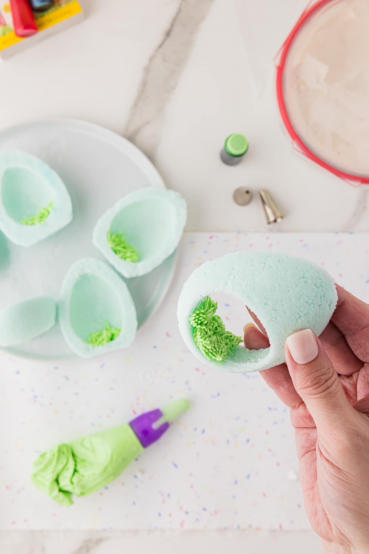 A closeup of grass made from frosting inside of a sugar egg