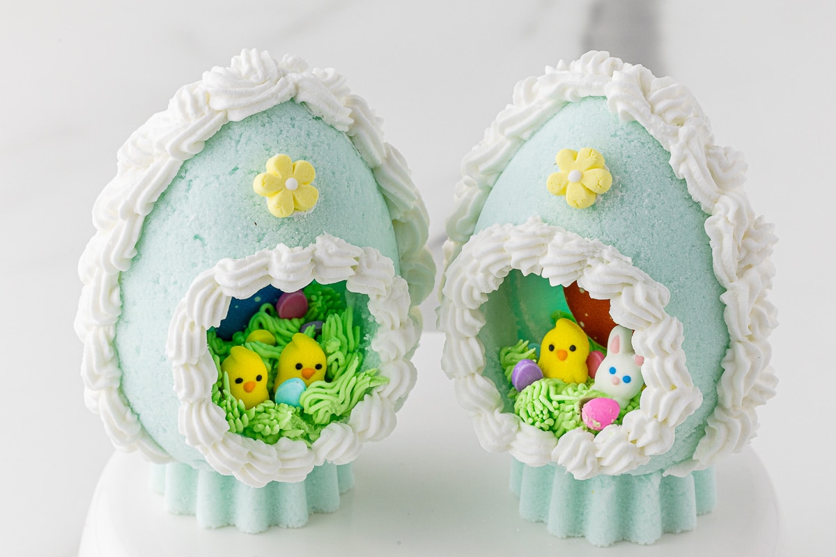 Close up of two homemade sugar eggs with baby chicks and bunnies inside