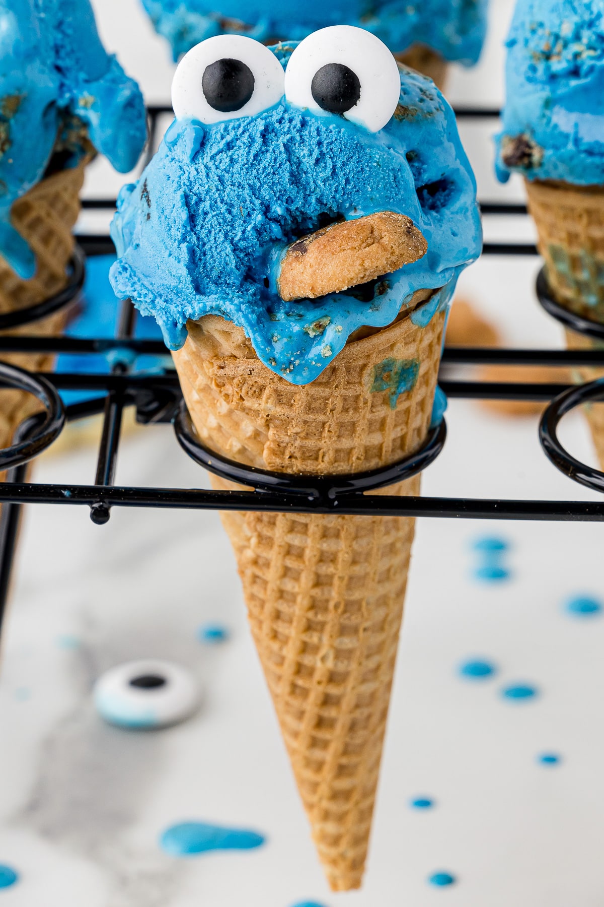 Cute clue ice cream in a sugar cone with candy google eyes to make it look like cookie monster with a cookie in his mouth