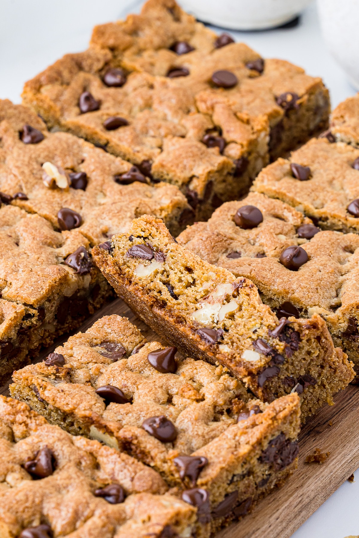 chocolate chip cookie bars on a wooden cutting board