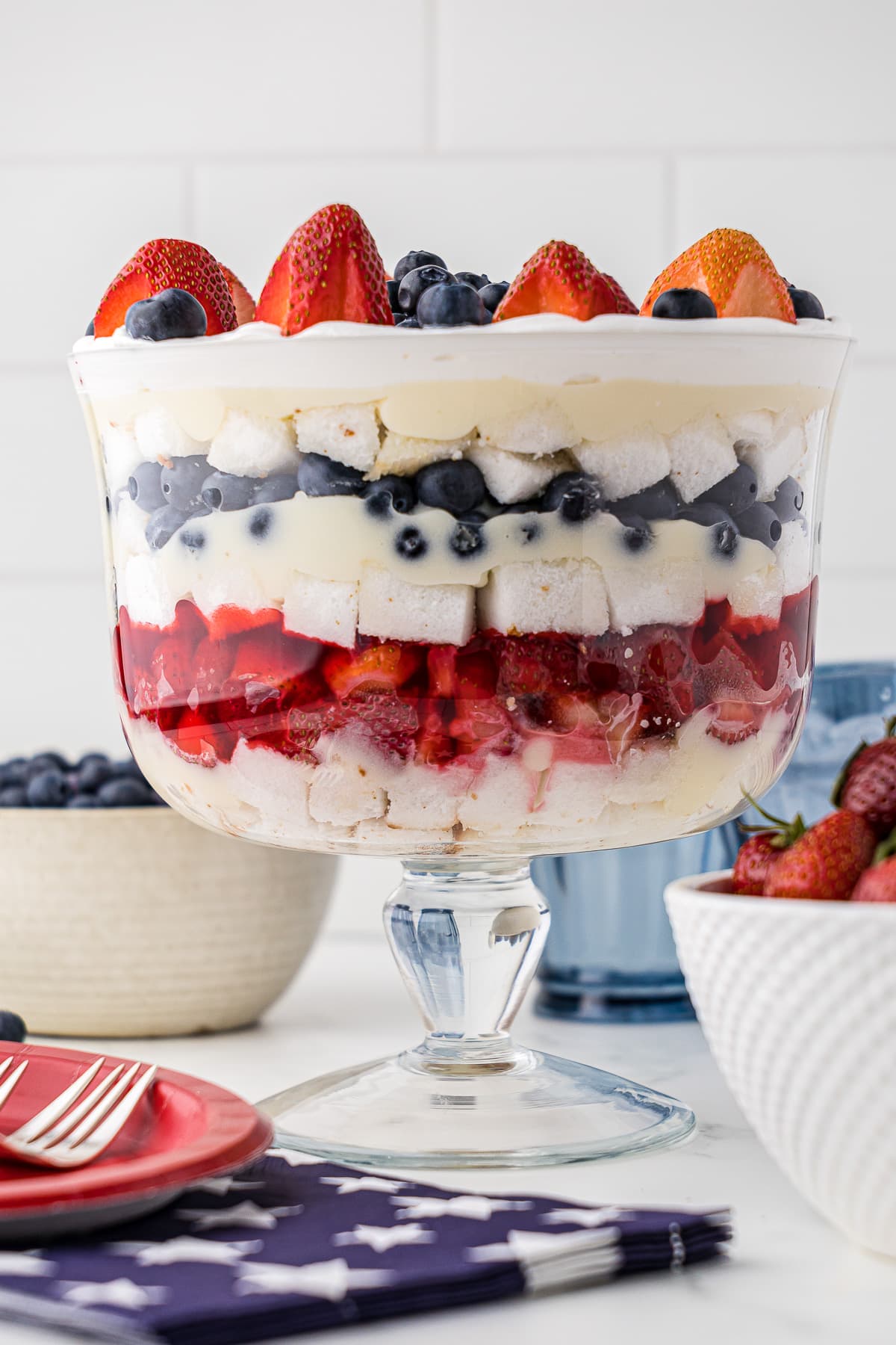 Strawberry and blueberry layered trifle with patriotic napkins and forks and red plates