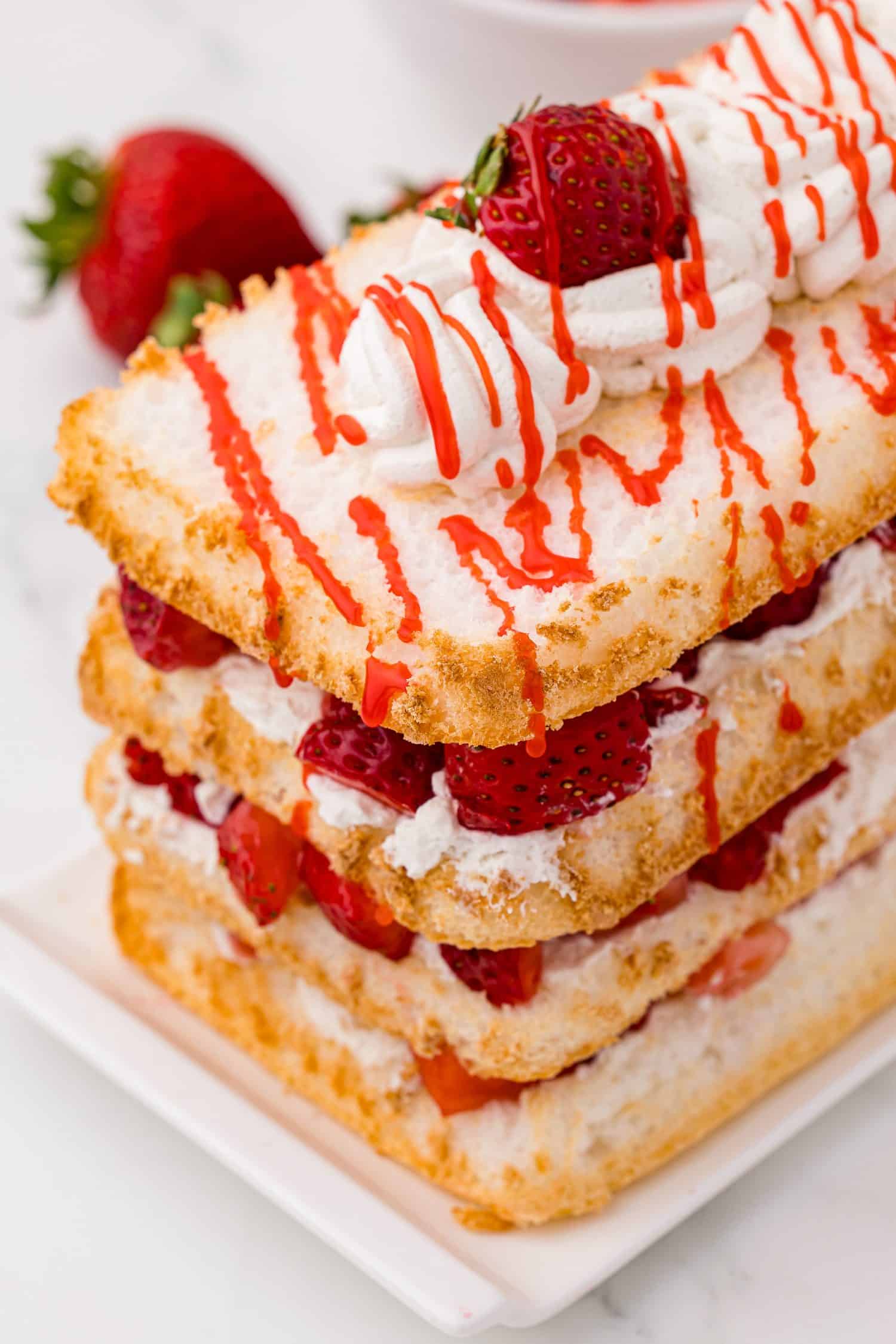 Layered angel food cake mix, drizzled with strawberry syrup.