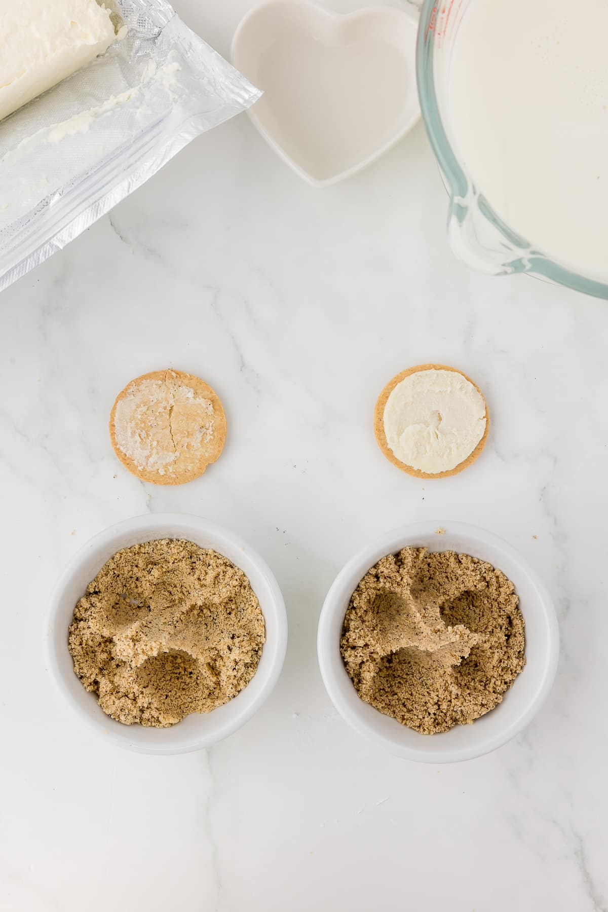 crumbled golden oreo cookie on a white marble countertop.