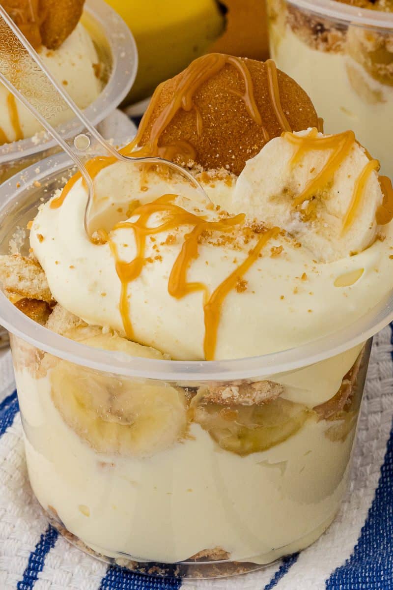 Close up of a layered banana pudding dessert cup topped with vanilla wafers