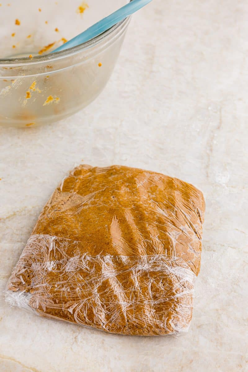 gingerbread cookie mixture wrapped in plastic wrap