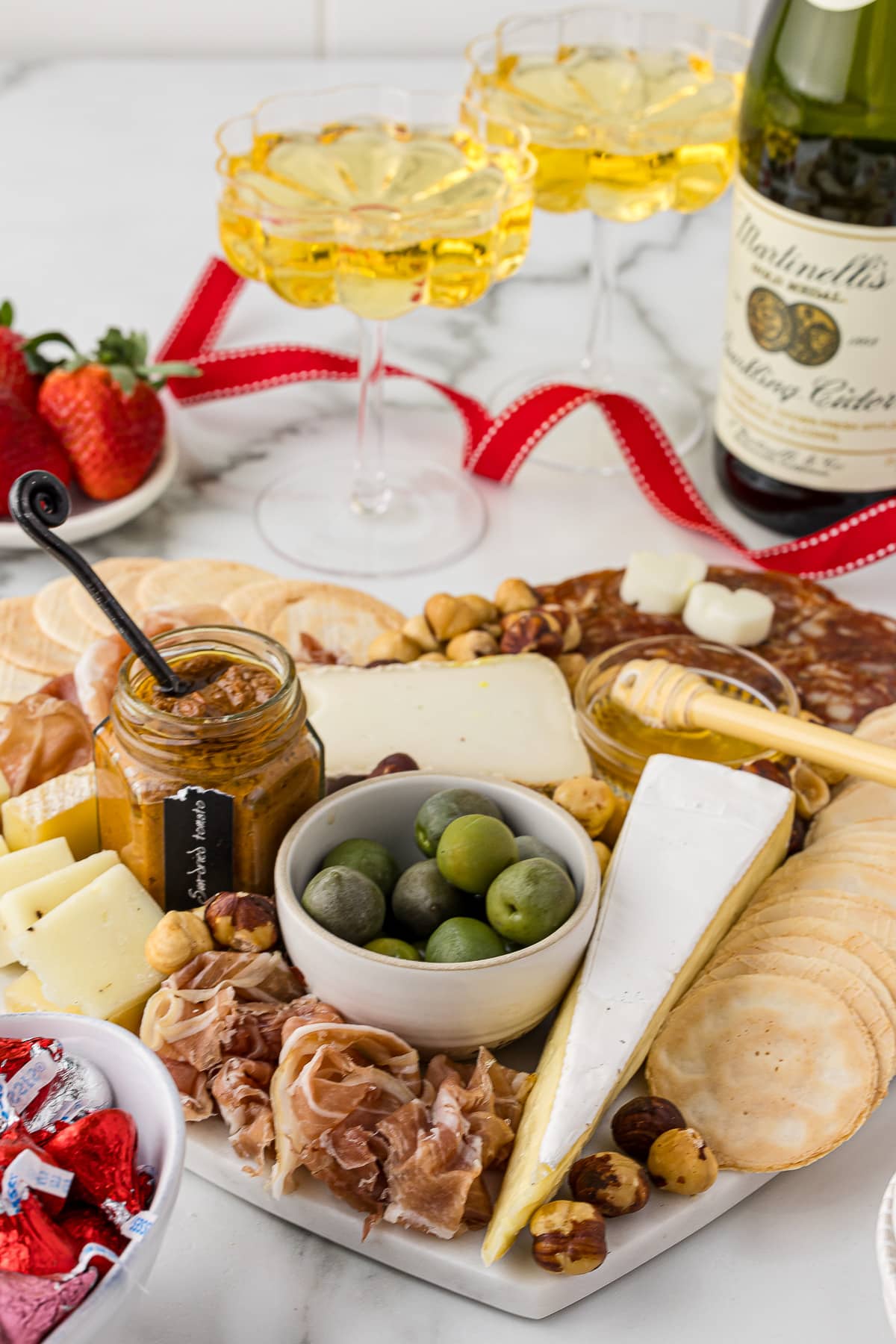 Olives, cheeses, meats and crackers on an appetizer tray for a party