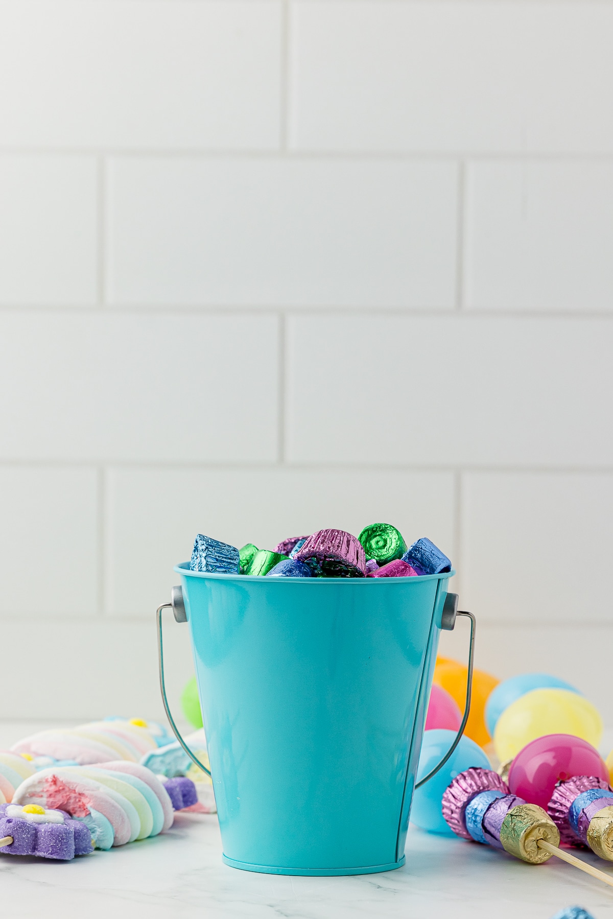 blue pail filled with reeses's mini peanut butter cups and easter rolos