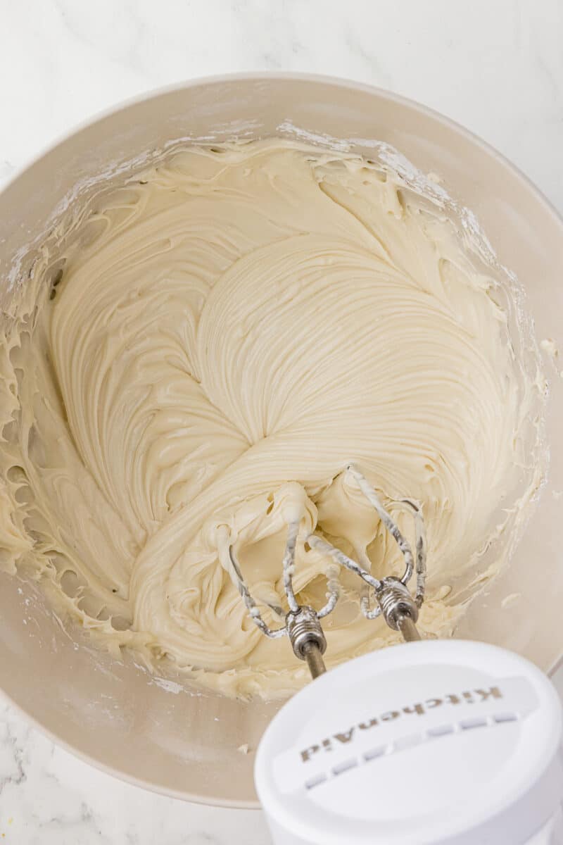 cream cheese frosting in a batter bowl with kitchenaid cordless mixer