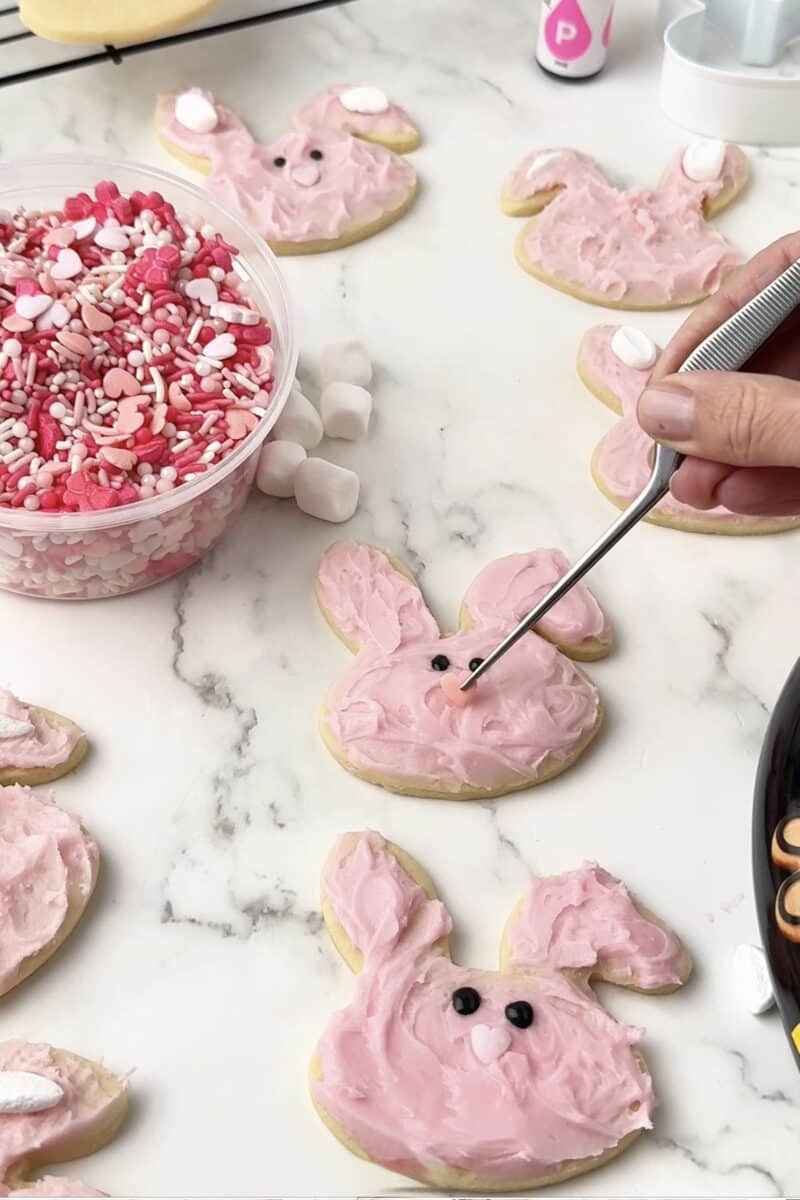 Decorating Easter sugar cookies with heart shaped nose