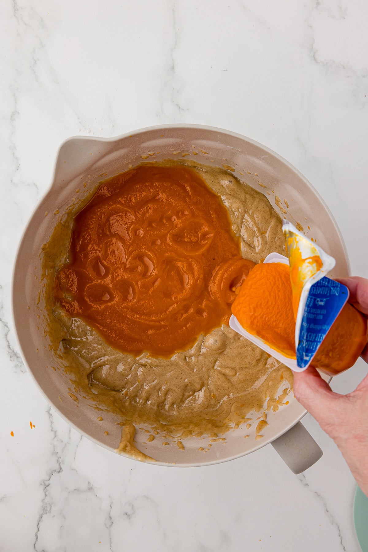 Gerber carrot baby food in batter bowl on white countertop