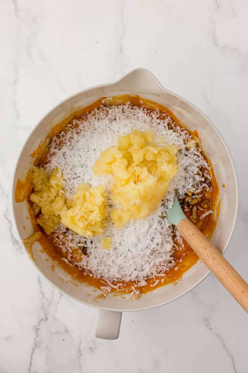 batter with shredded coconut and pineapple in a batter bowl
