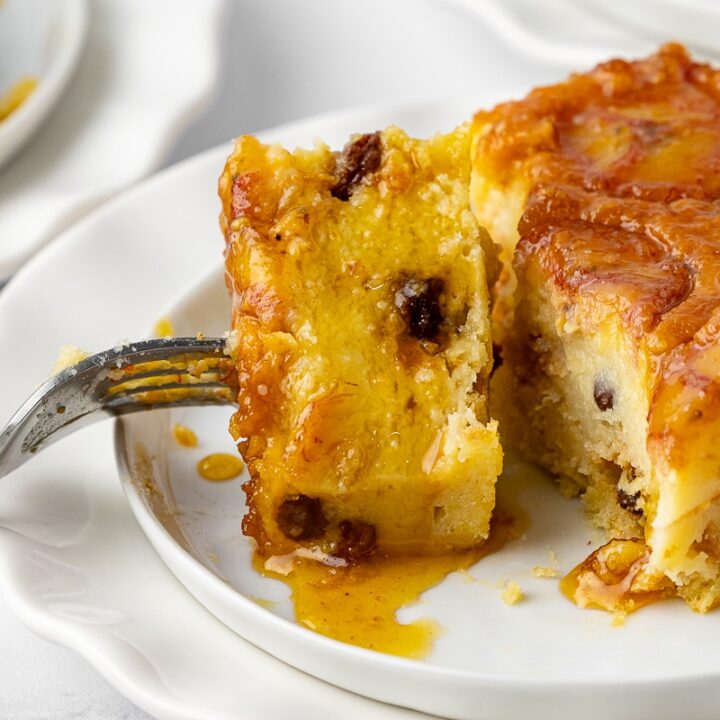 closeup of bread pudding on a dessert plate with a fork