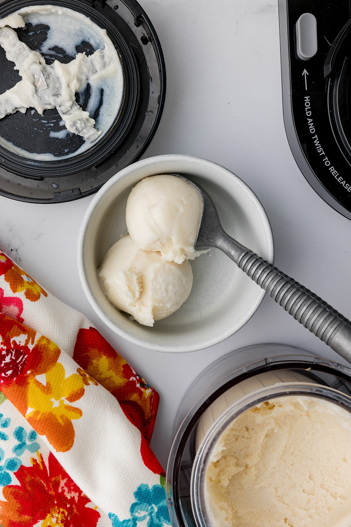 Bowl with scoops of vanilla ice cream and a colorful floral towel