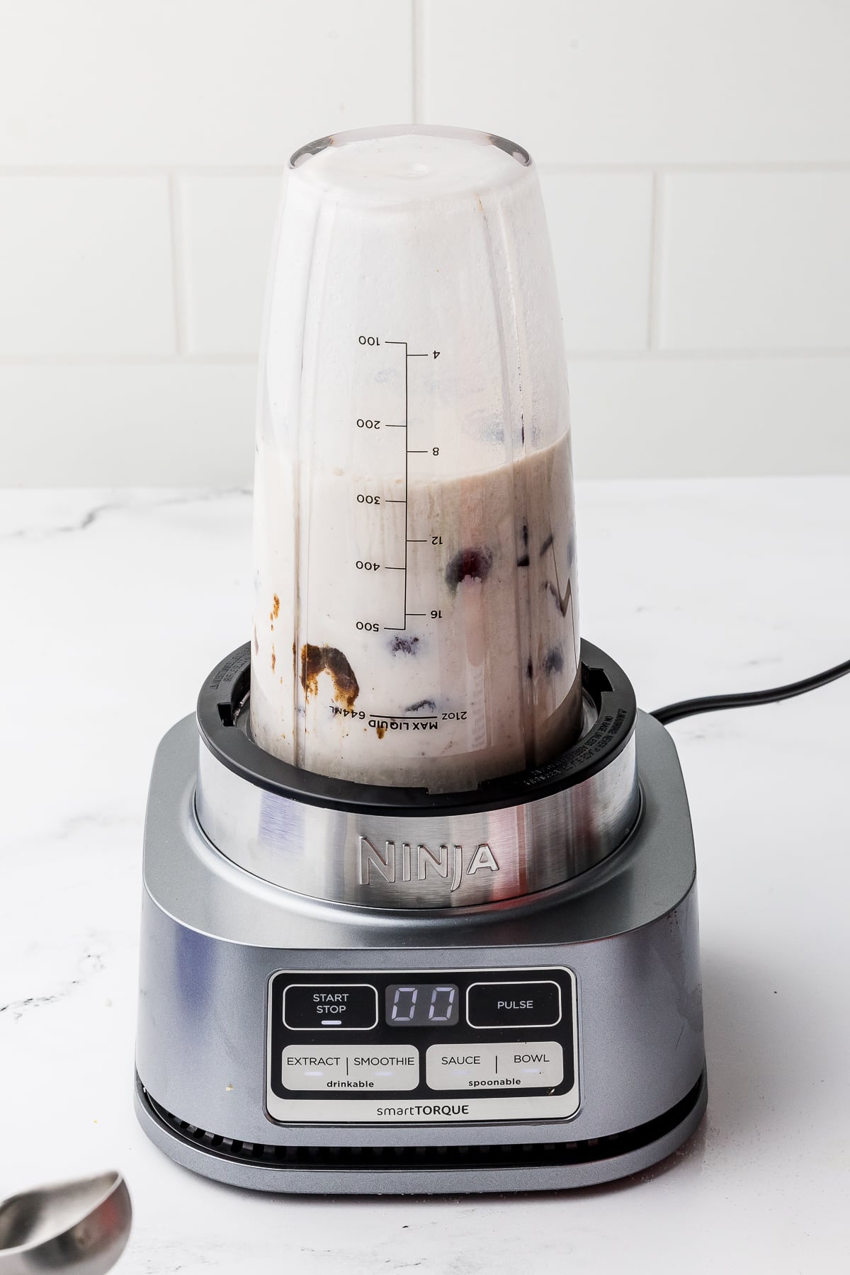 Ninja smart torque blender with cherry ice cream in it