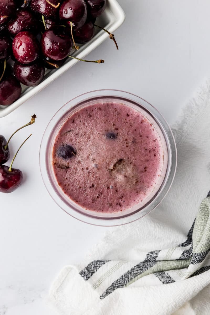 frozen cherry ice cream before it is spun in the ninja creami pint bowl