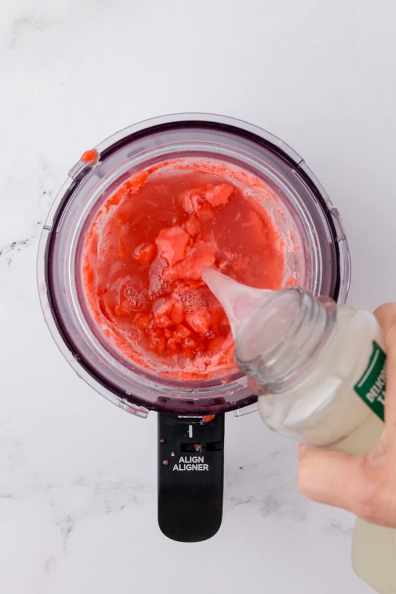 pouring lemonade into a ninja creami pint jar