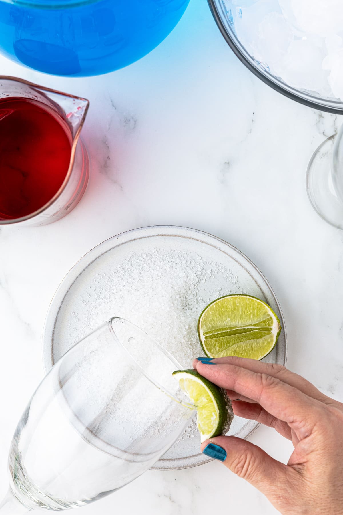 lemon being rubbed on the rim of a glass