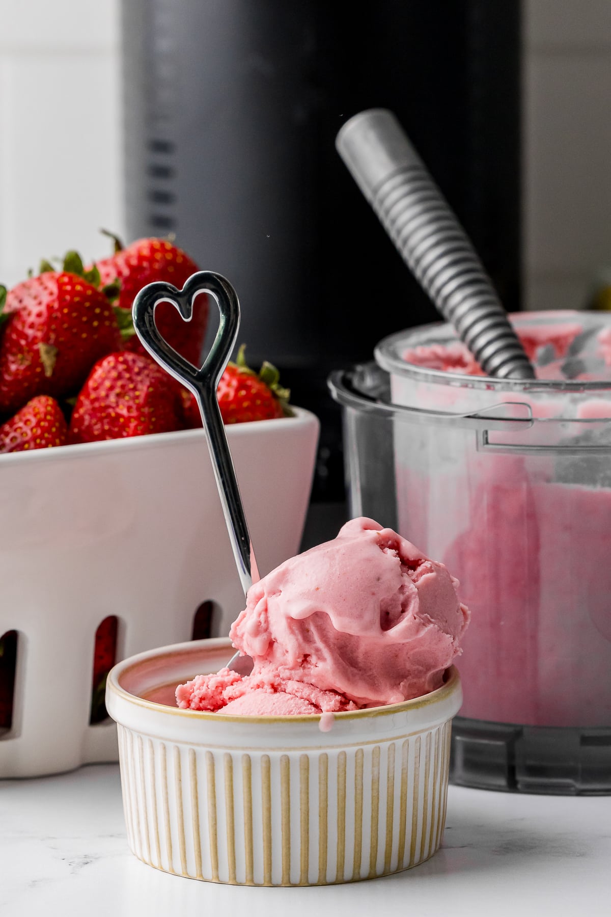 heart spoon in a ramekin filled with ninja creami strawberry ice cream