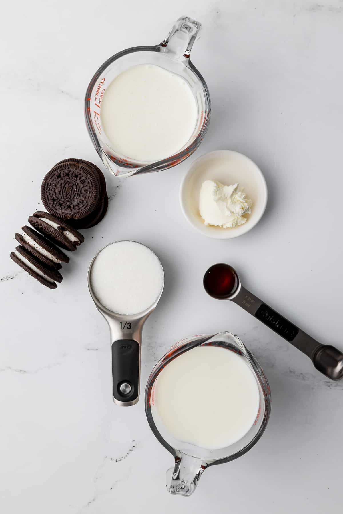 ingredients for cookies and cream ice cream recipe, oreos, milk, sugar, vanilla, oreos, cream, and cream cheese