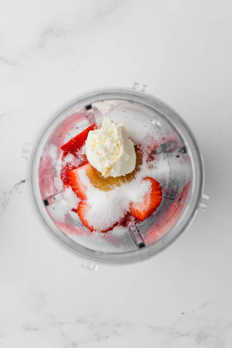 unblended ingredients for strawberry ice cream in a ninja blender