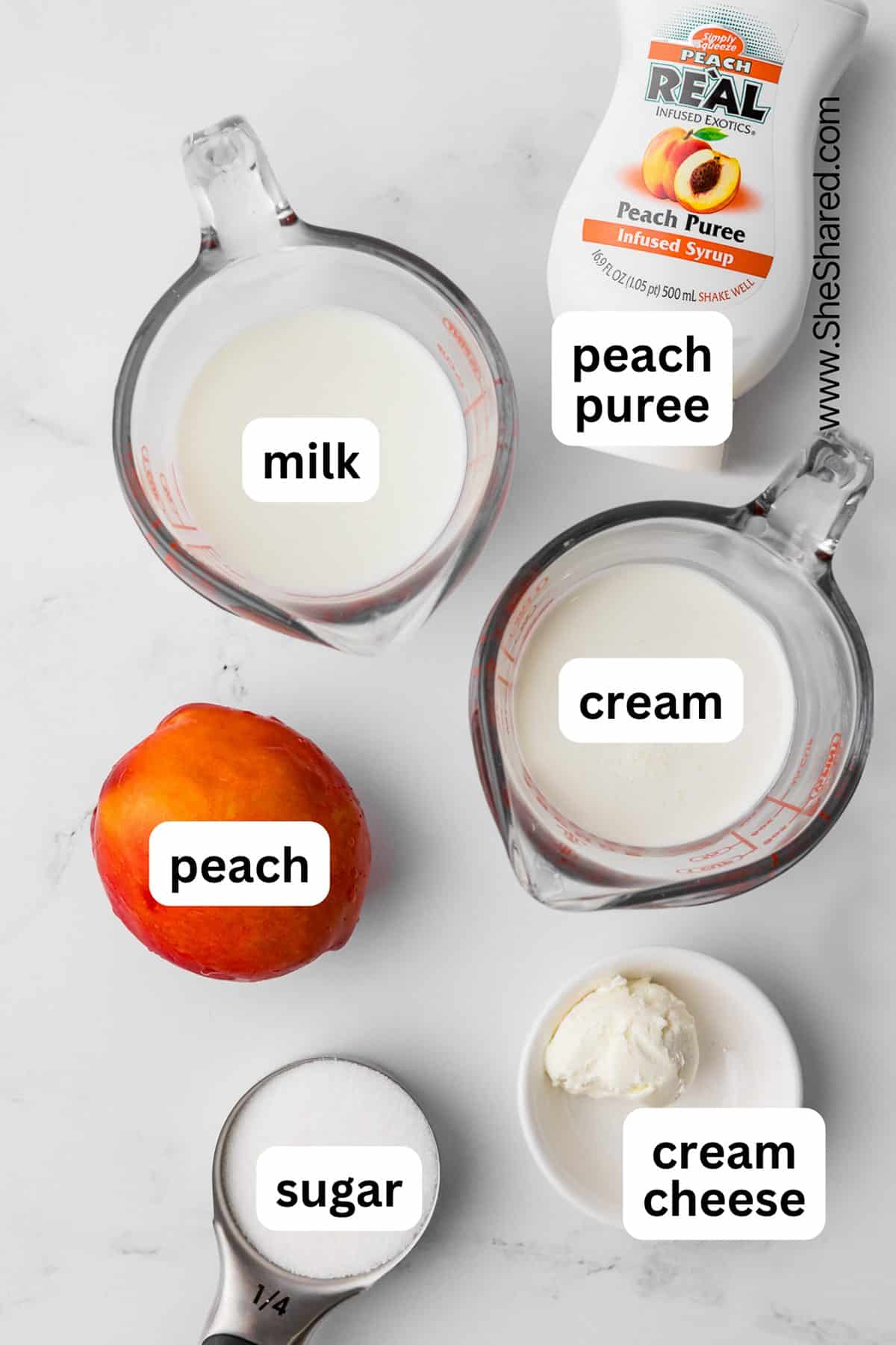 ingredients for ninja creami peach ice cream including milk, cream peach puree, peach, sugar, and cream cheese on a white countertop