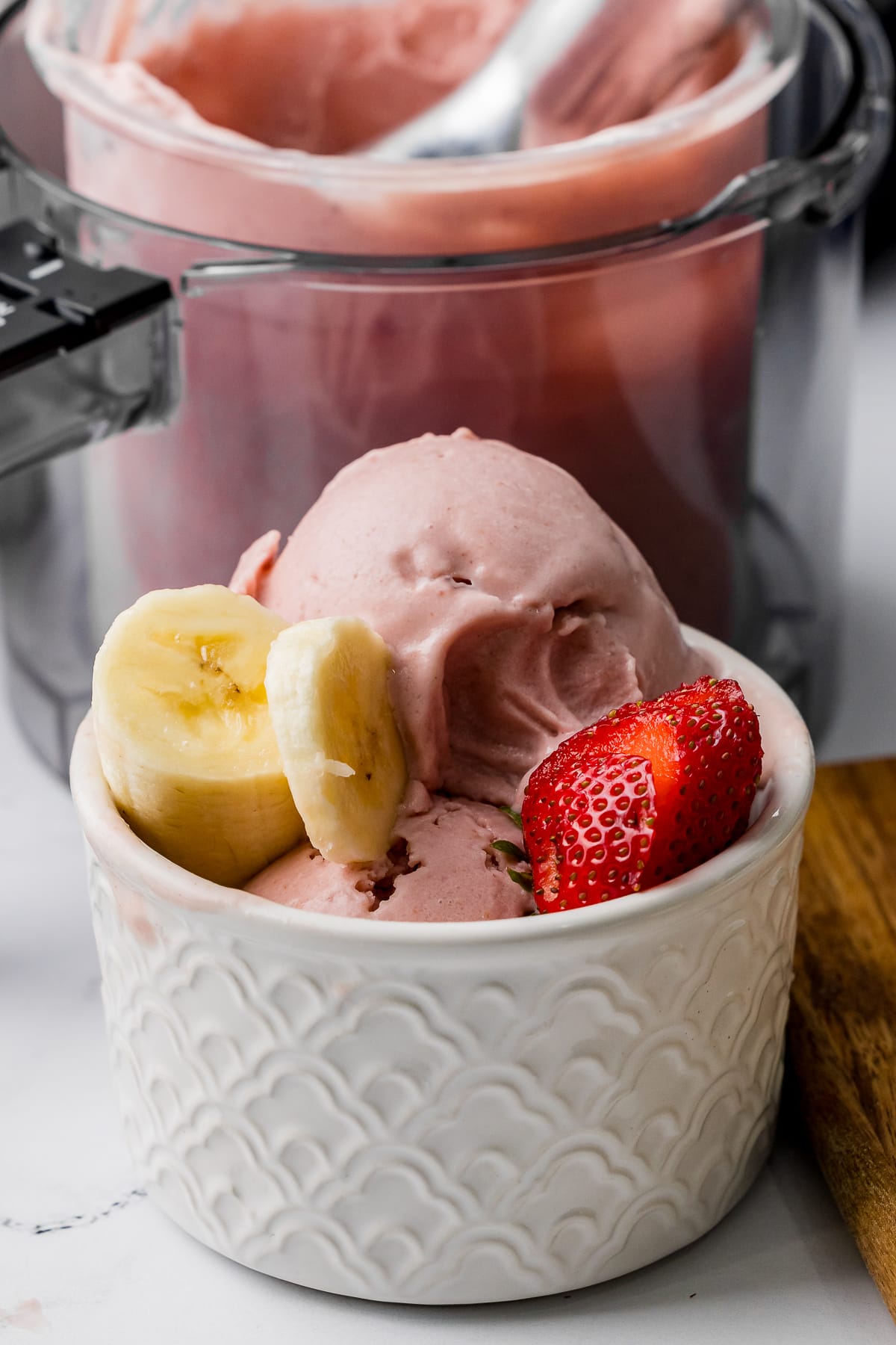 bowl of banana strawberry ice cream with fresh strawberries and sliced bananas