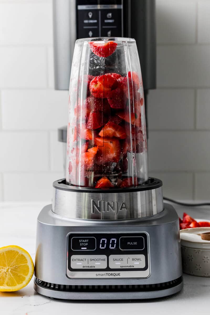 strawberries in a ninja smart torque blender on a white counter