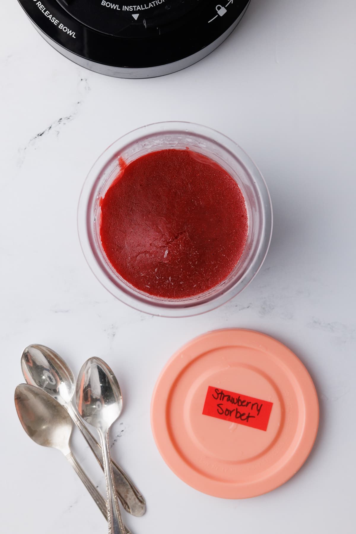 ninja creami pint jar filled with strawberry sorbet