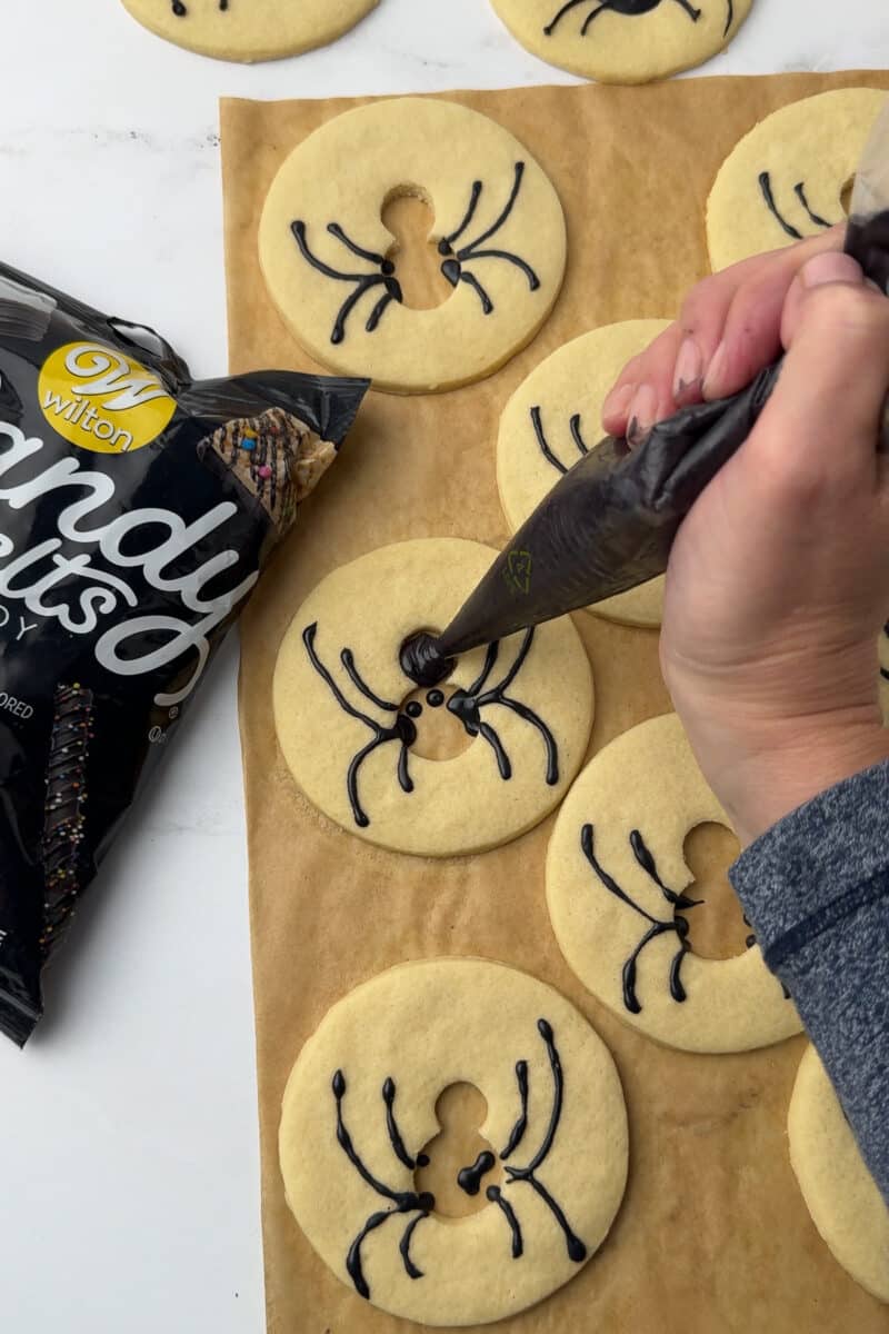 filling in spider cookie bodies with melted wilton candy melts