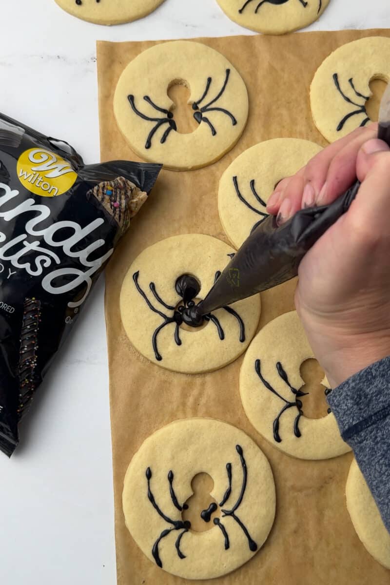 filling in spider cookie bodies with wilton candy melts