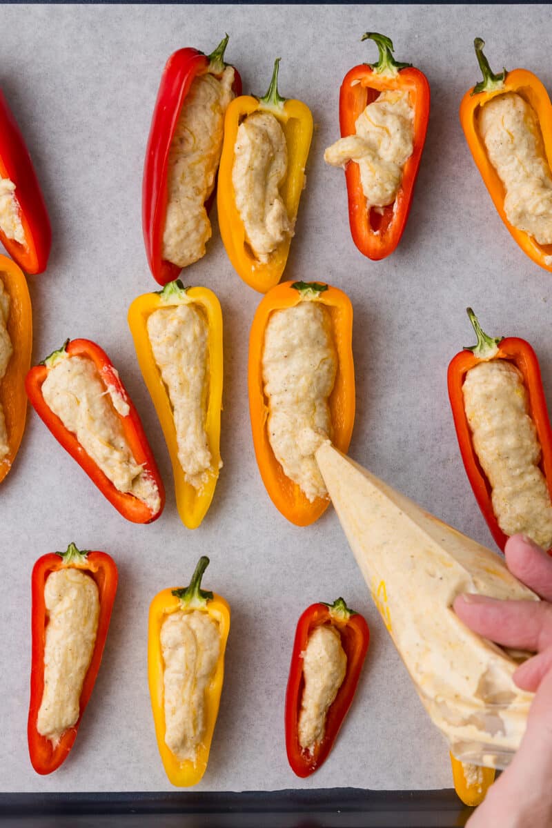 filling halved peppers with cottage cheese queso