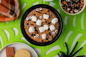 Bowl of Halloween hot cocoa dip on a festive spooky season party table