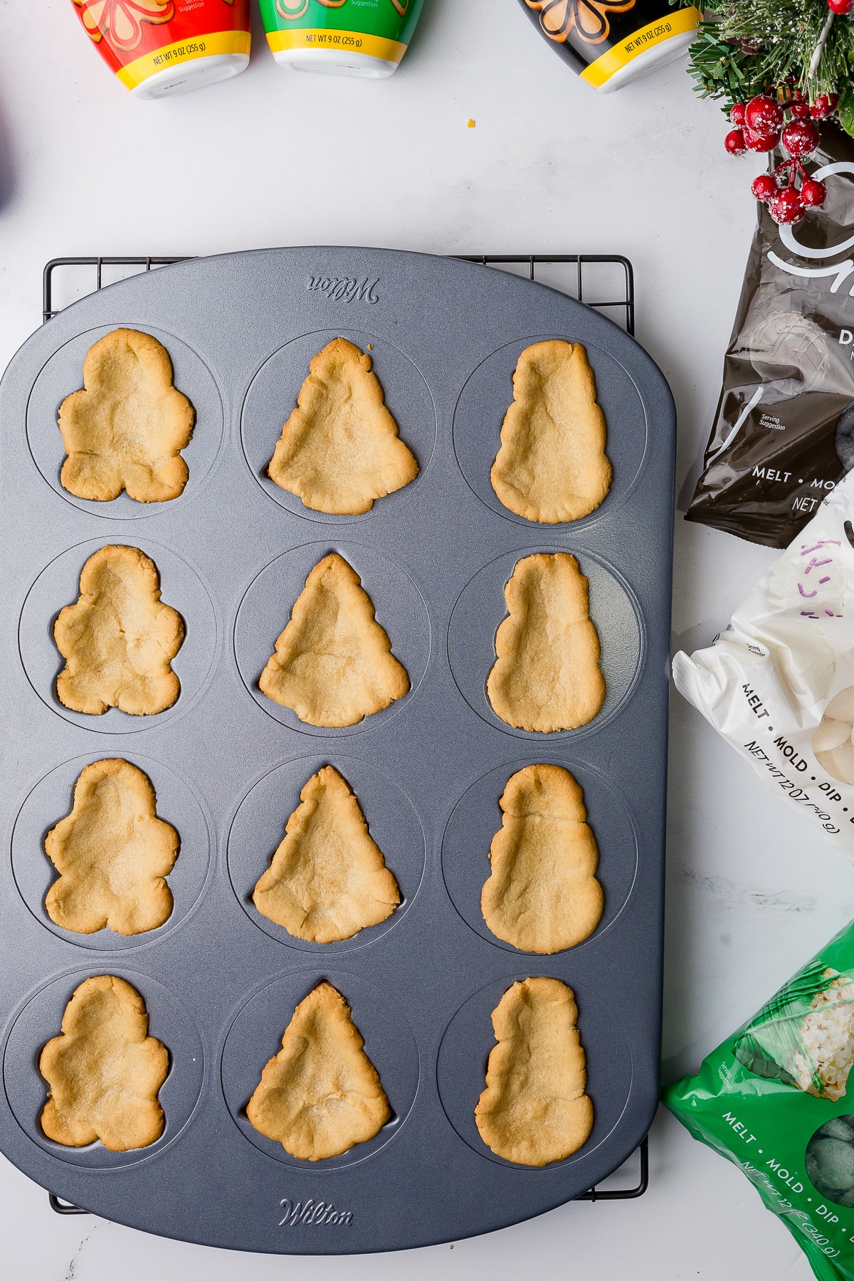 Cookies in a Wilton Baking Sheet on a counter with decorating supplies