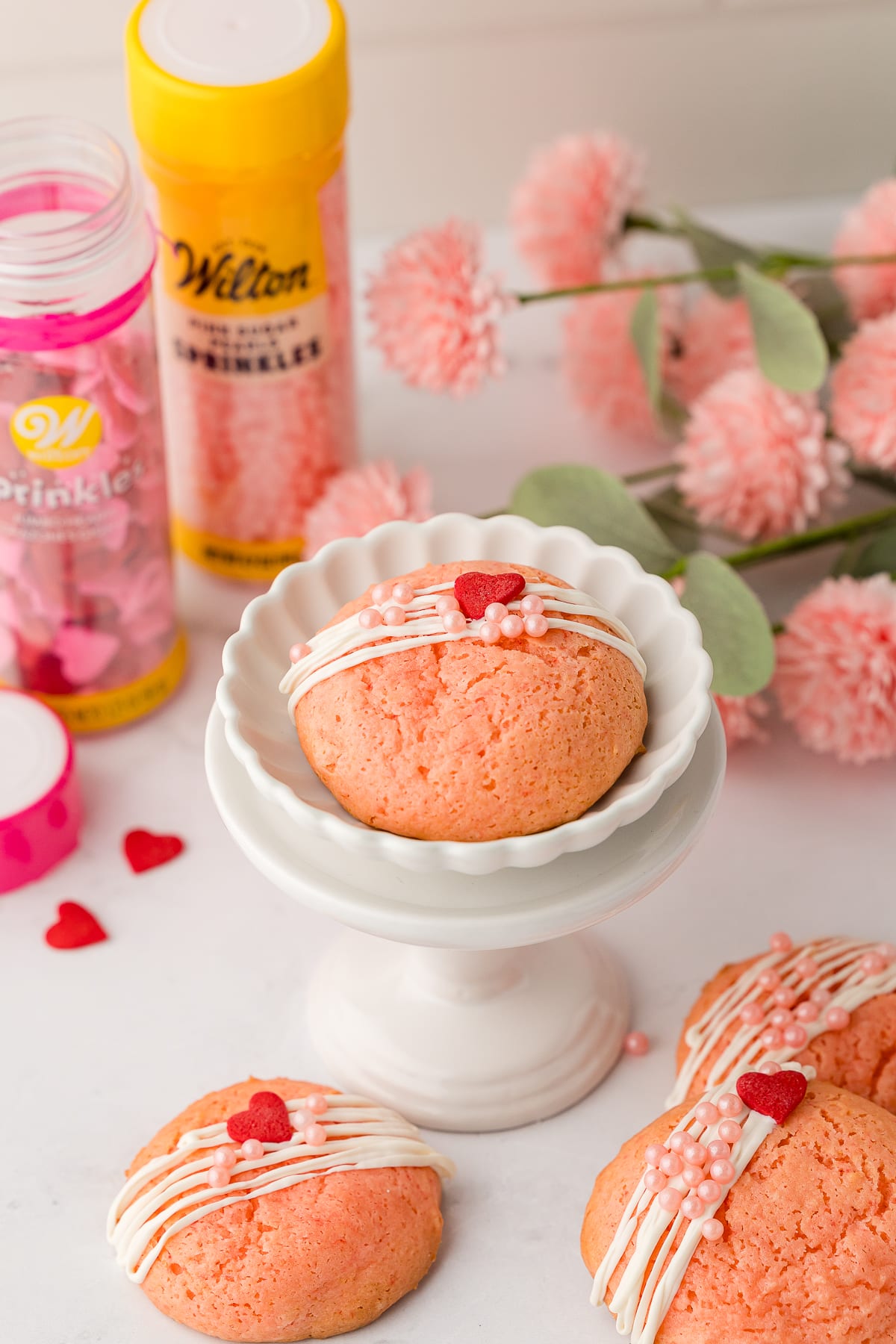 strawberry cake mix cookies decorated with white chocolate and wilton sprinkles