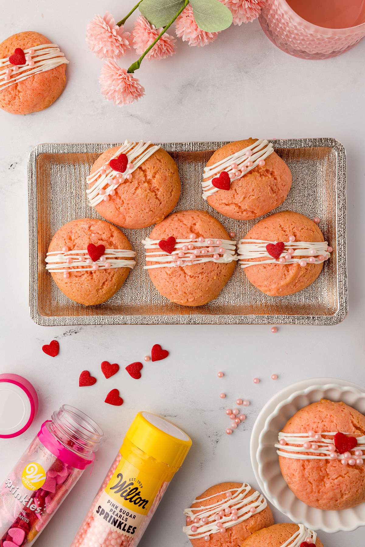 strawberry cake mix cookies decorated with white chocolate and wilton sprinkles on a serving dish