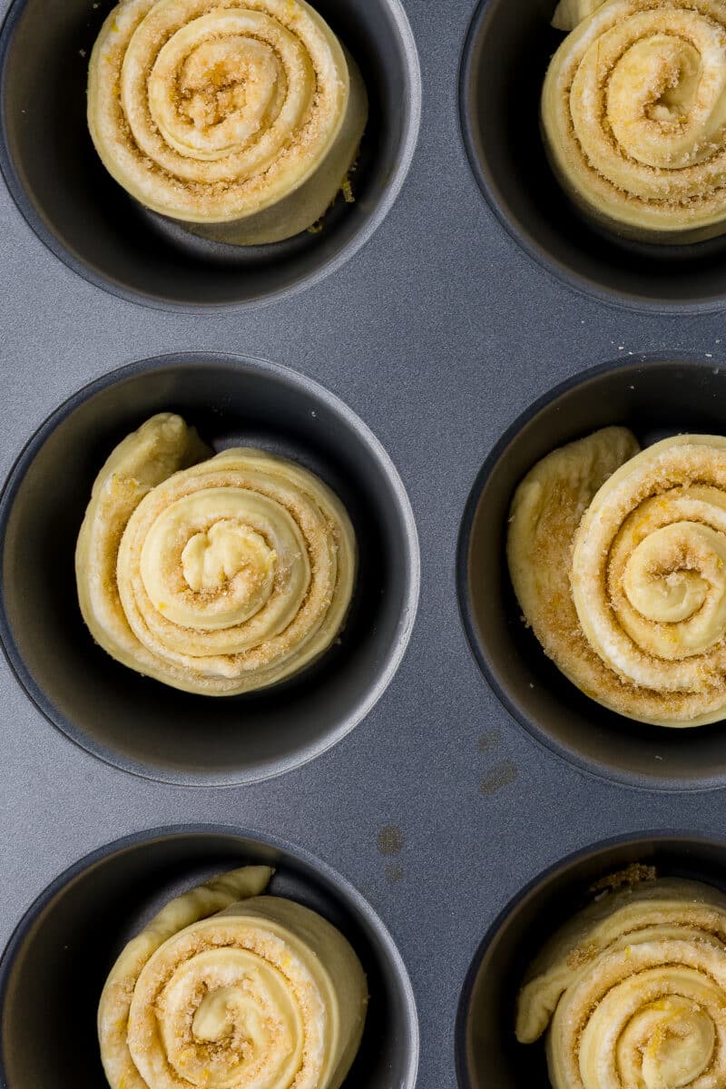 unbaked lemon rolls in a muffin tin