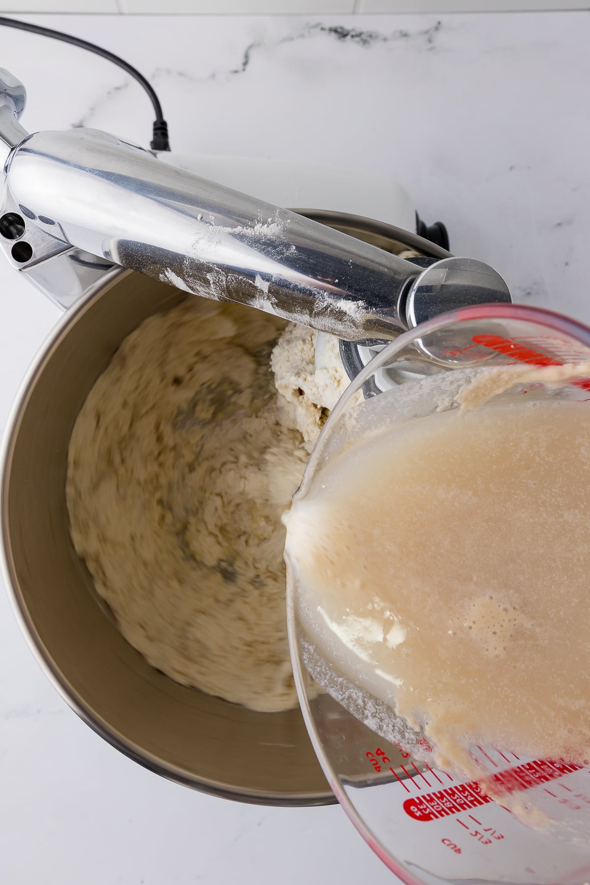 pouring yeast mixture into dry ingredients