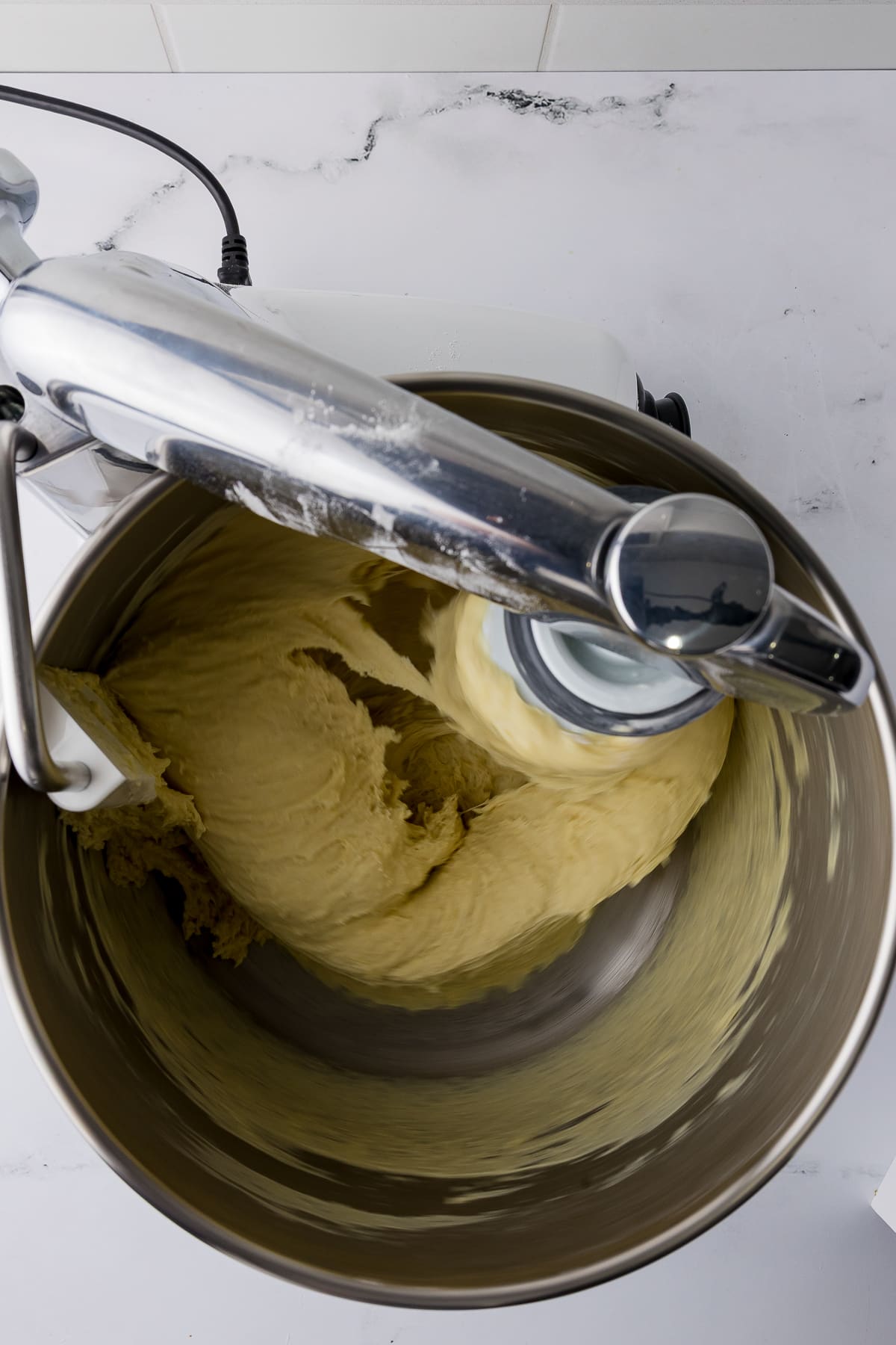 dough being mixed in stand mixer