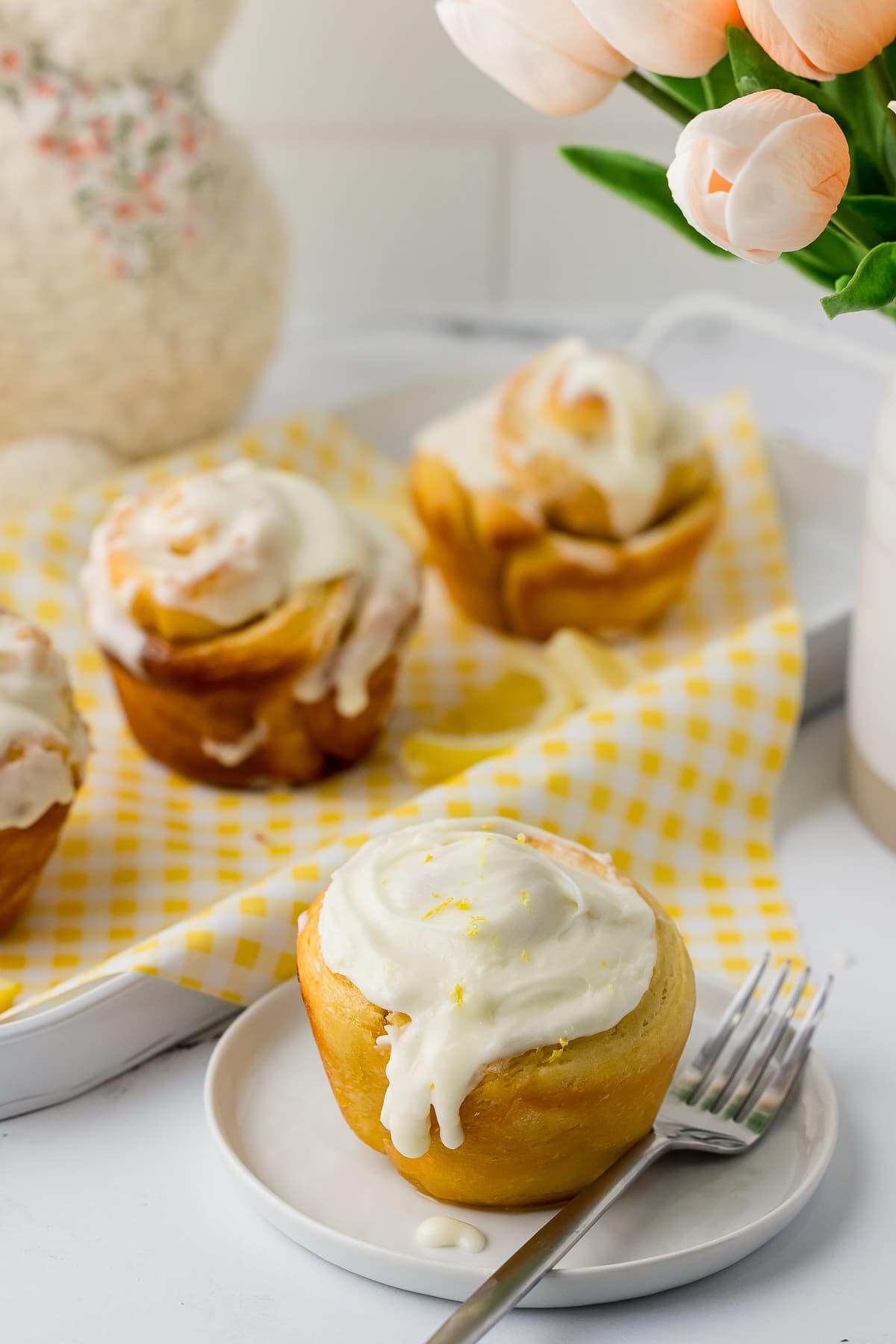 finished lemon sweet roll with lemon zest on the top of cream cheese frosting