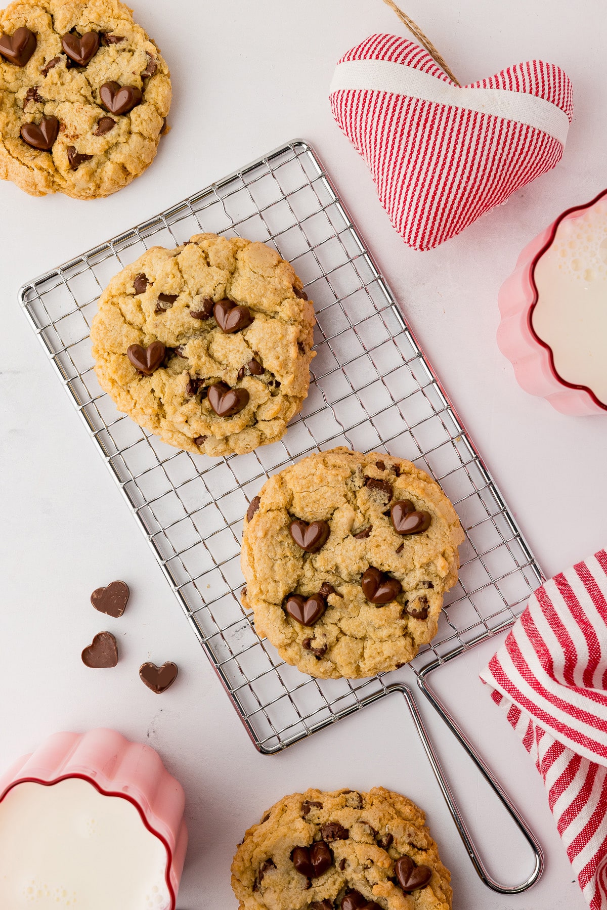 two cookies on a wire cooking rack with. couple of cookies on a white counter