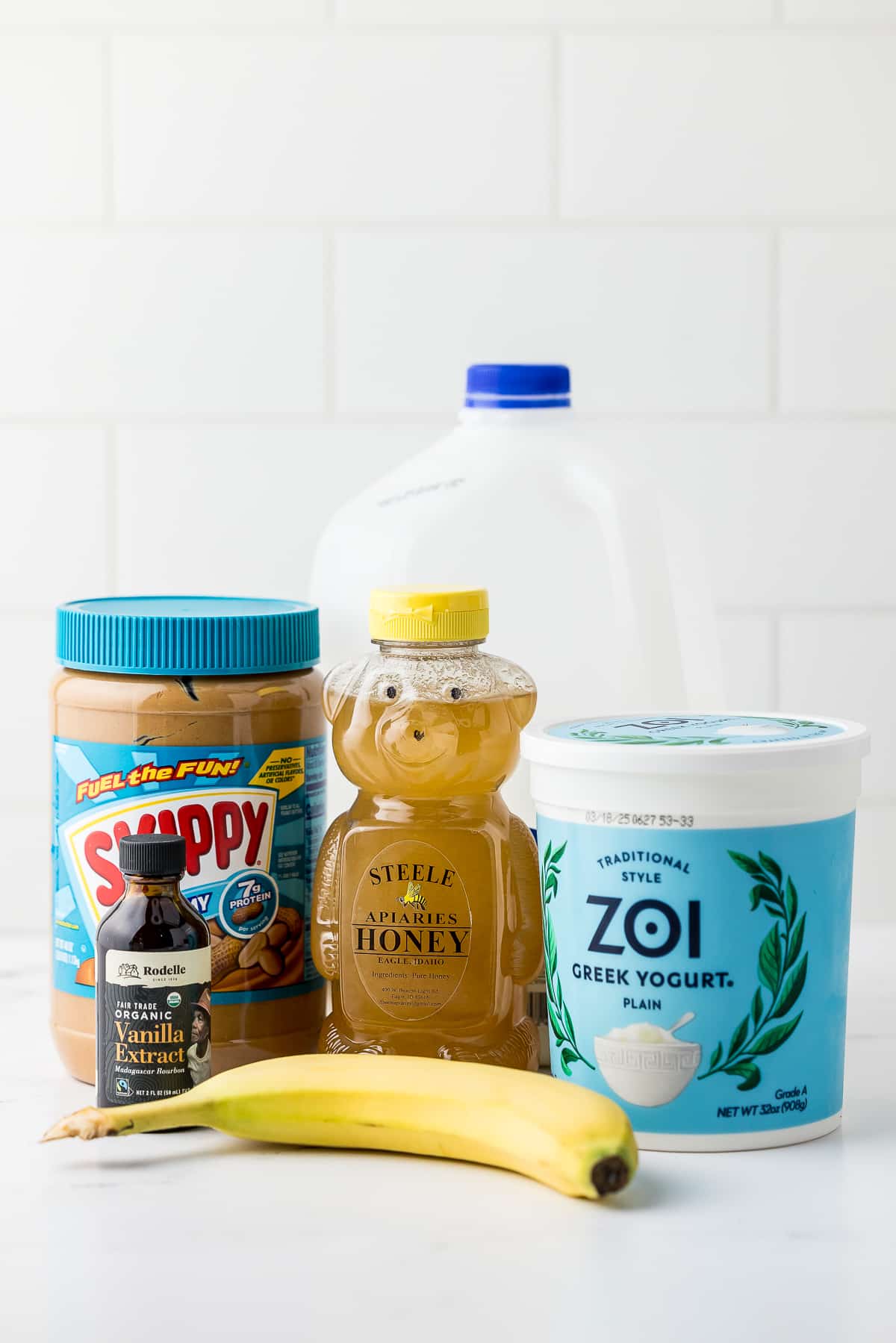 ingredients for peanut butter banana frozen yogurt on a white counter