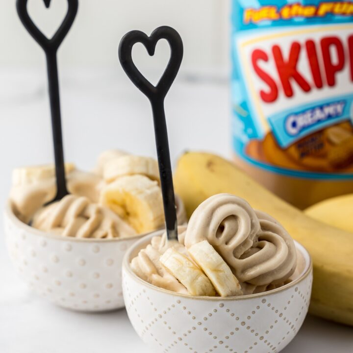 small bowls of frozen yogurt with a heart shaped spoon and skippy creamy peanut butter and a banana