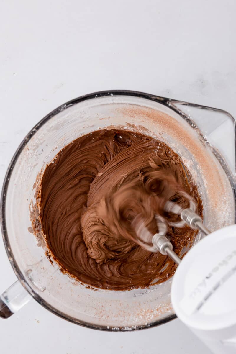 mixing chocolate frosting in a batter bowl