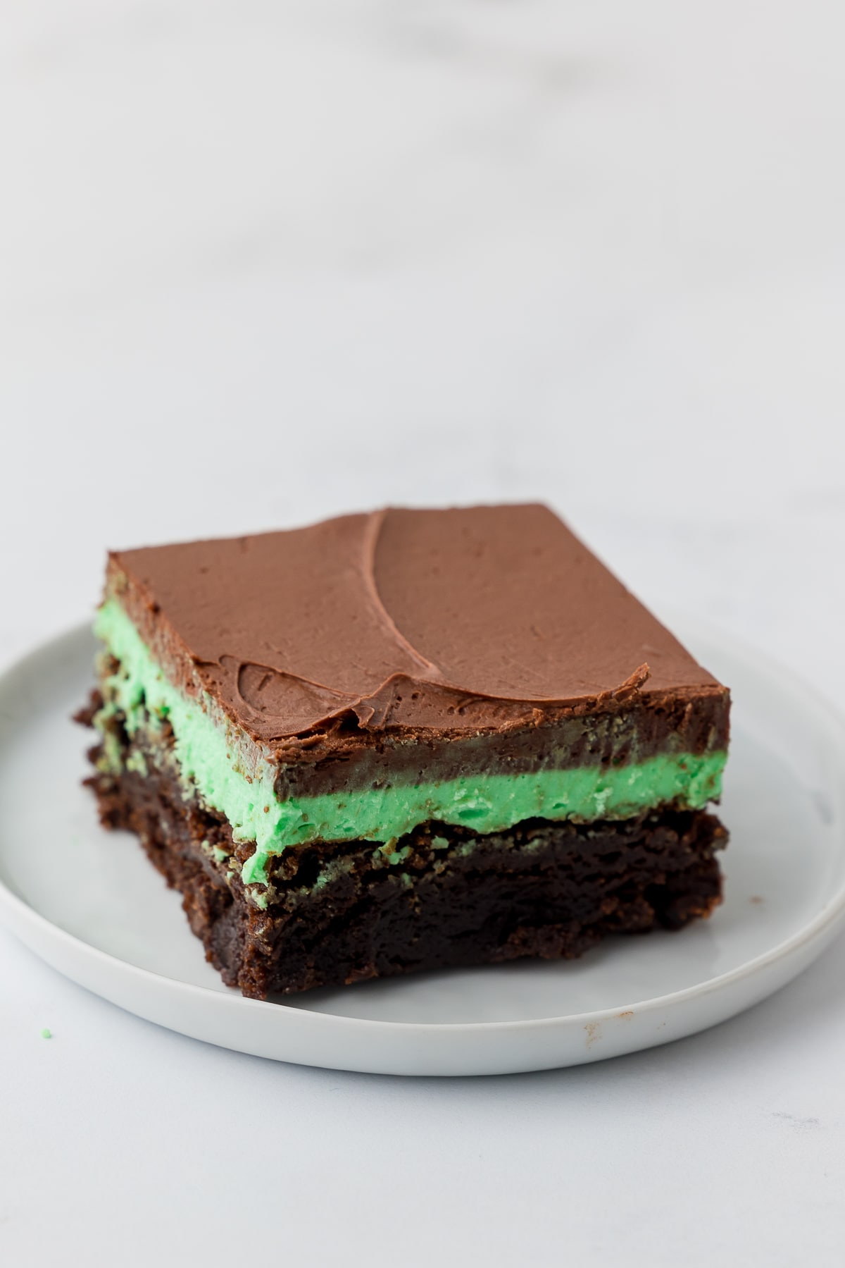 finished cut brownie on a white plate