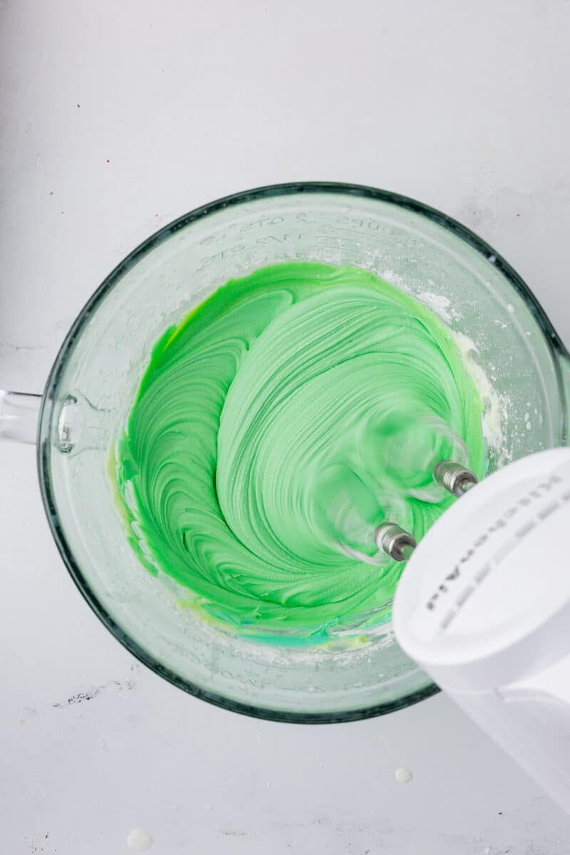 mixing frosting in a batter bowl with the kitchen aid mixer