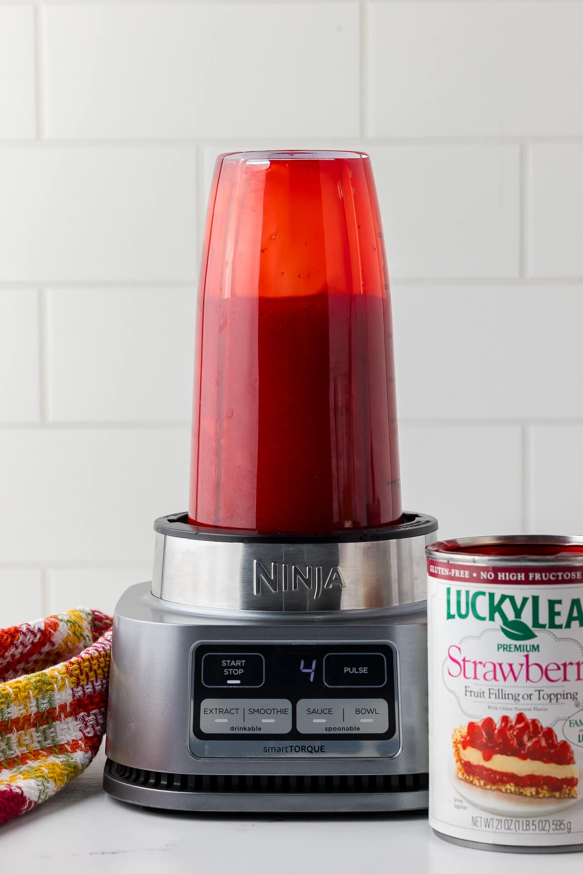 ninja blender filled with strawberry fruit filling