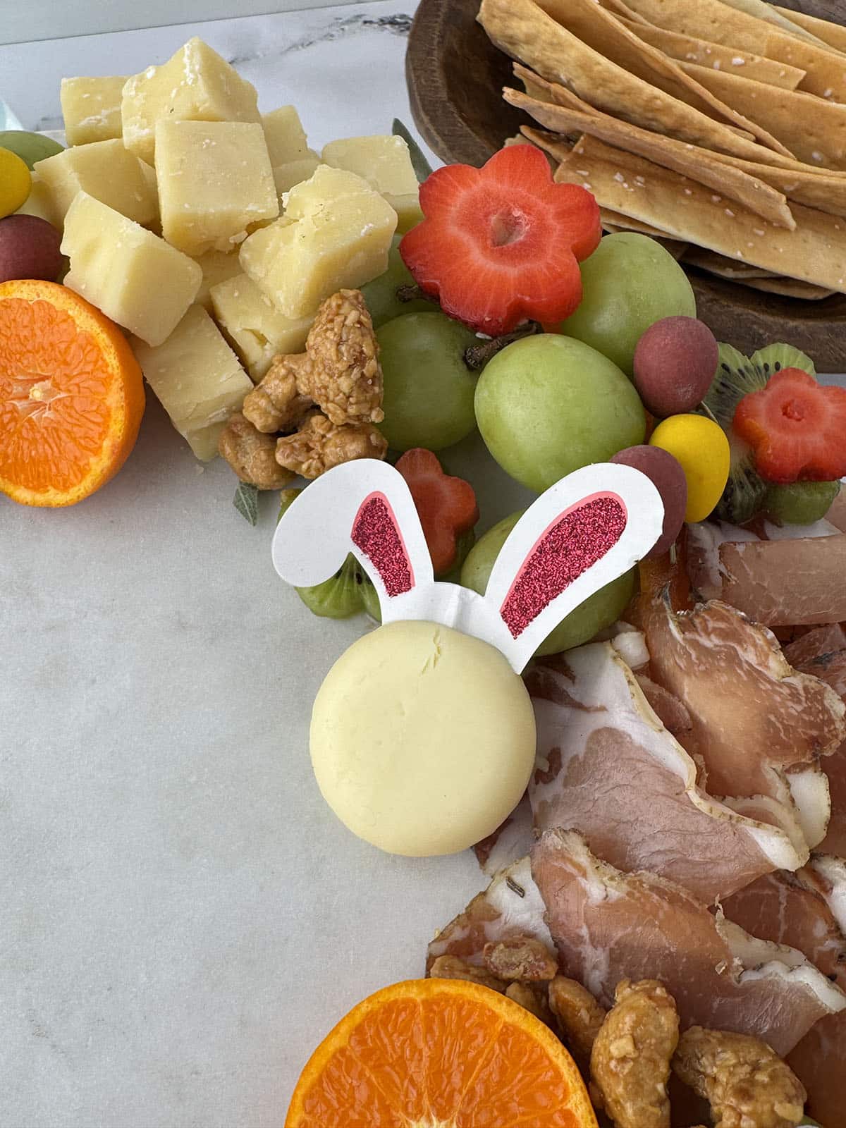 close up of a spring charcuterie board wreath made of fruits and meats and cheeses