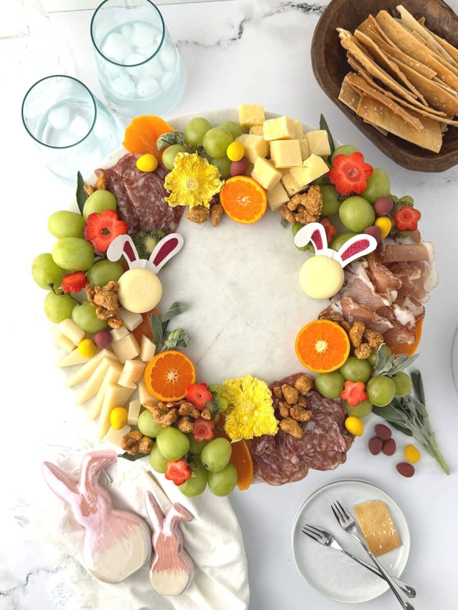 Large edible wreath made of meats, cheese and fruit on a marble counter