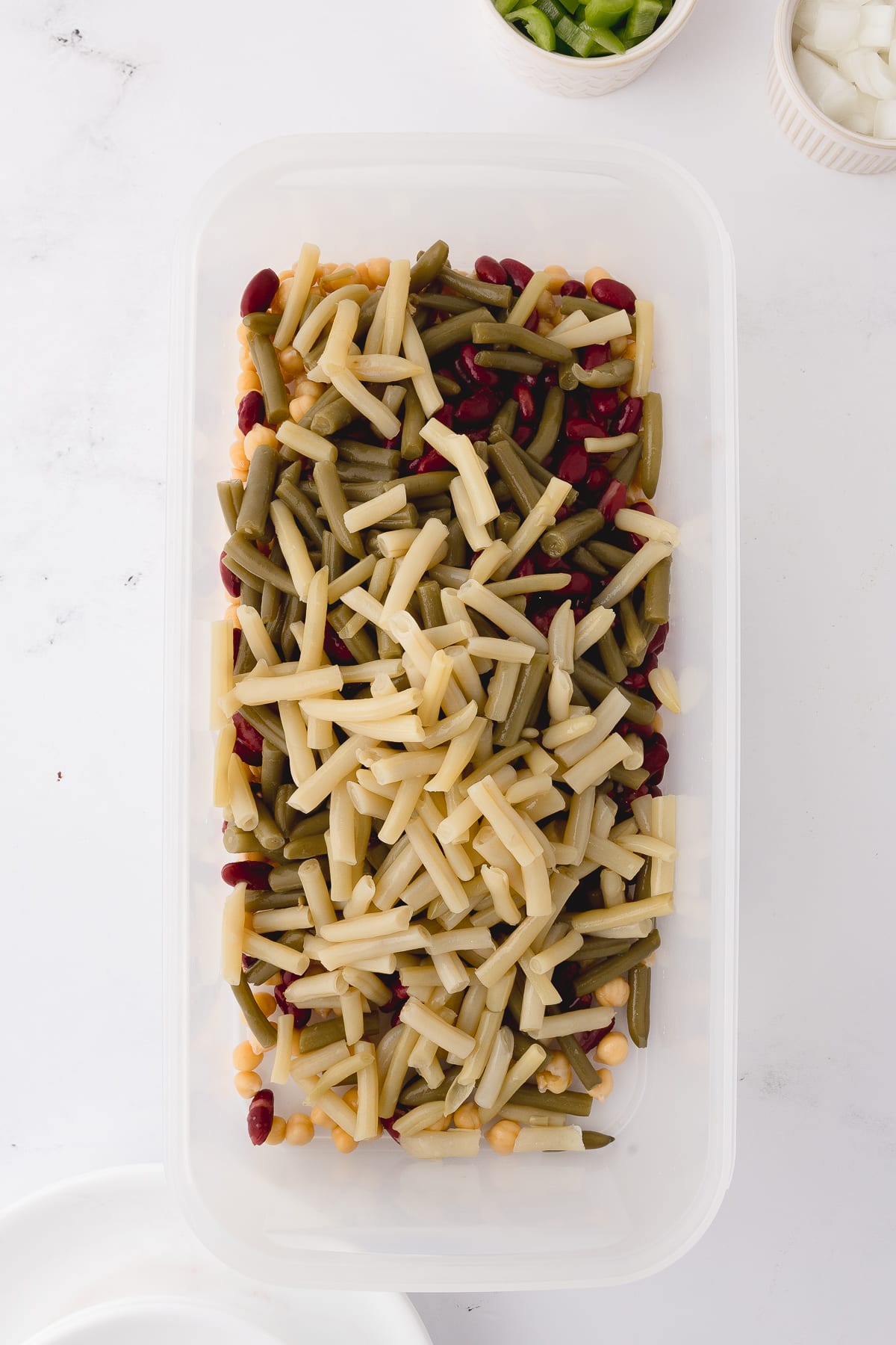 tupperware rectangular dish with all of the beans inside