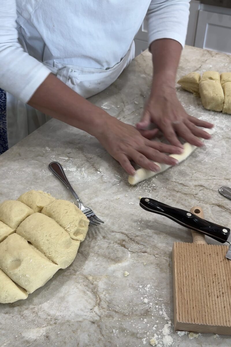 rolling out dough ropes to be cut into gnocchis